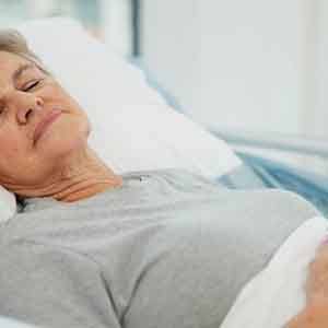 a woman resting comfortably after undergoing dental treatment