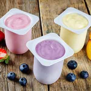 three cups of yogurt with different flavors