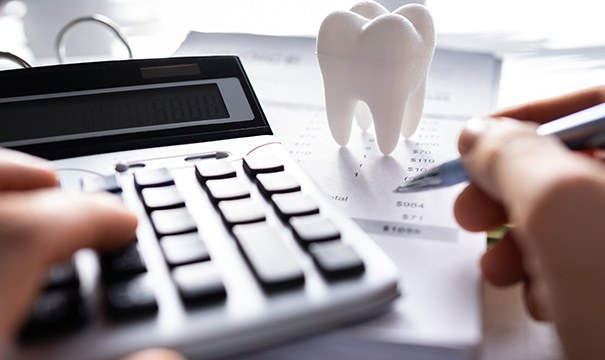 A patient calculating the cost of root canal treatment