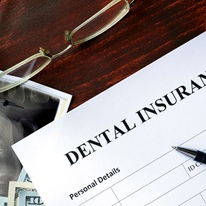 A dental insurance form on a wooden table