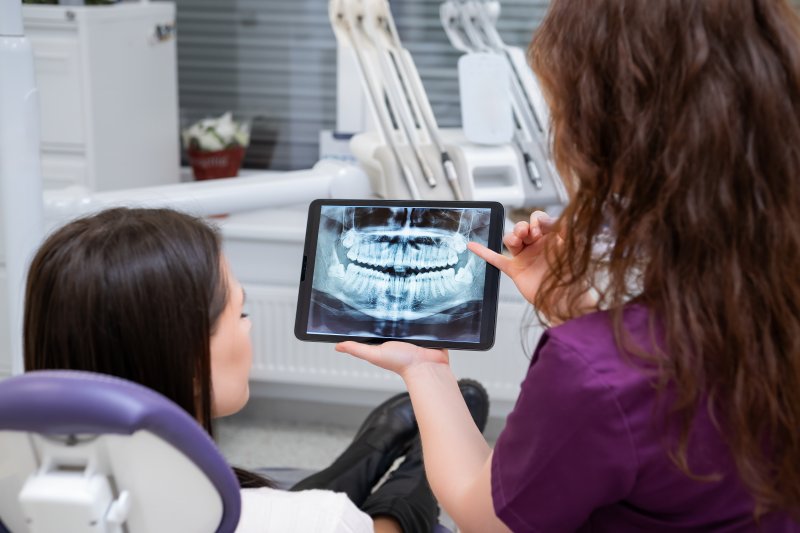 Patient talking with dentist about dental implants