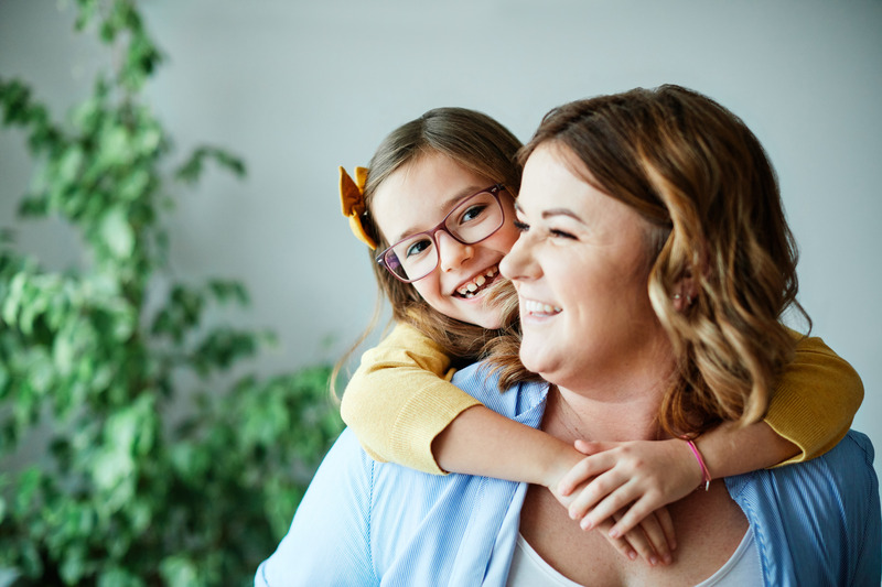 Child smiling with parent after tooth extraction